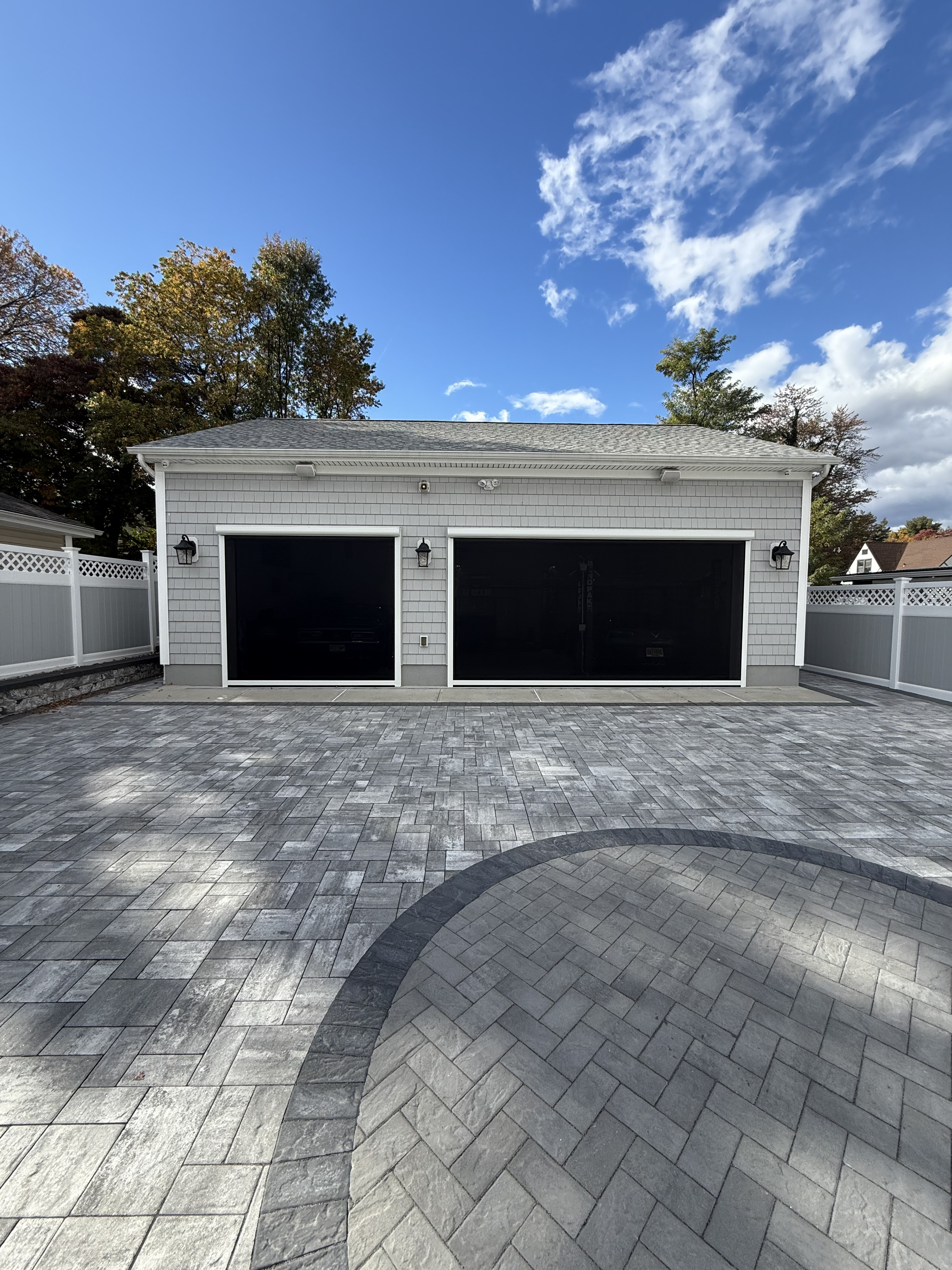 Garage bay with a full-height motorized screen lowered across the opening.